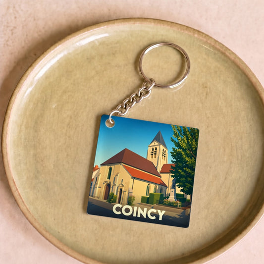 Porte-clés souvenir de la ville de Coincy avec une illustration stylisée de son église.