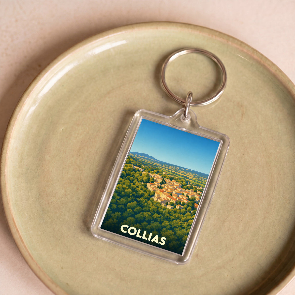 Porte-clés souvenir de la ville de Collias avec une illustration stylisée.