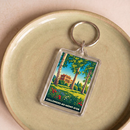 Porte-clés souvenir de la ville de Collonges-au-Mont-d'Or avec une illustration stylisée.