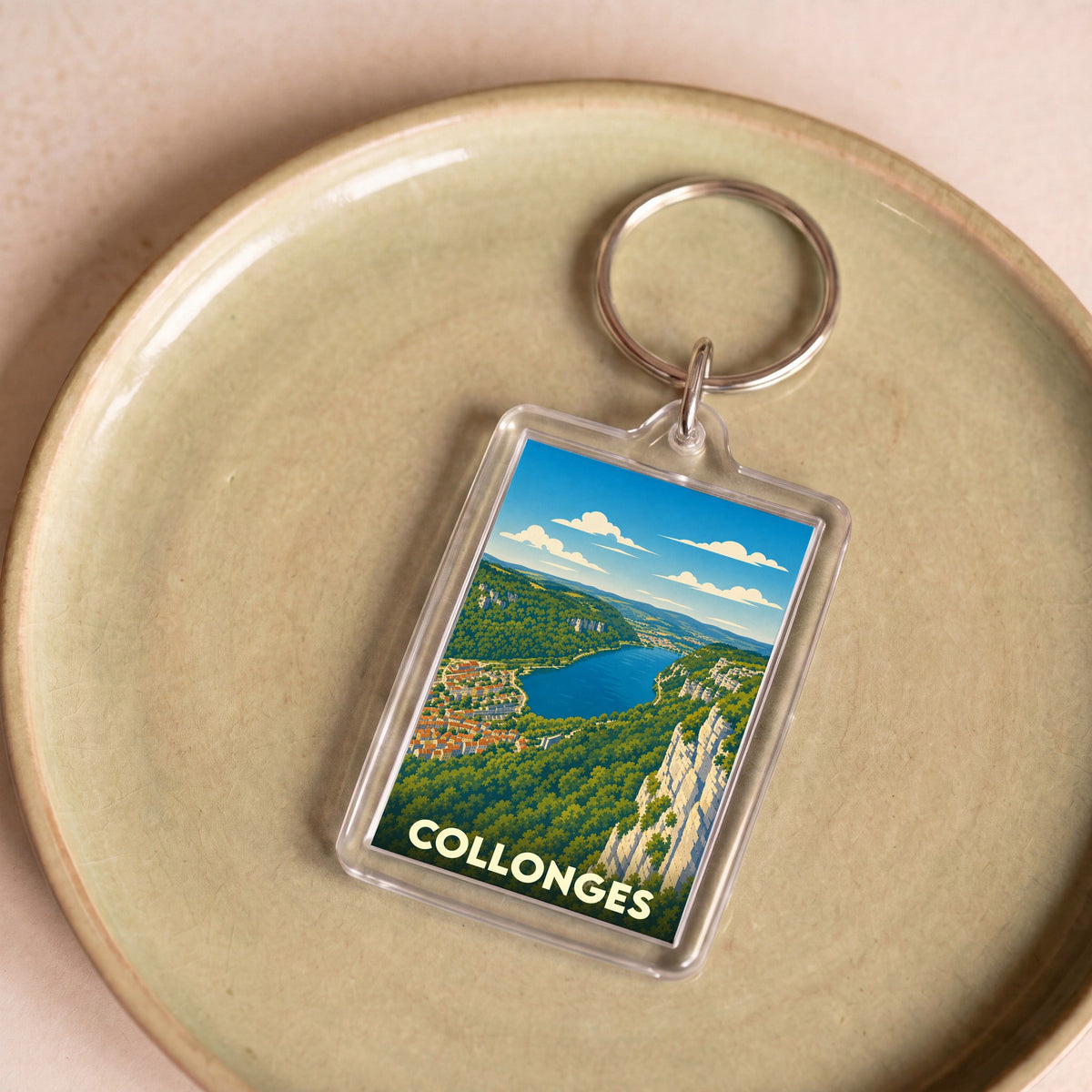 Porte-clés souvenir de la ville de Collonges avec une illustration stylisée d'un paysage panoramique.