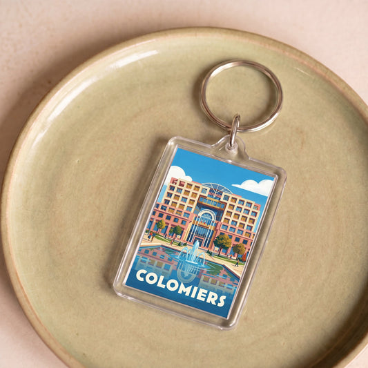 Porte-clés souvenir de la ville de Colomiers avec une illustration graphique et colorée.