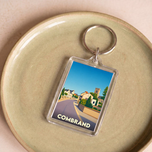 Porte-clés souvenir de la ville de Combrand avec une illustration stylisée.