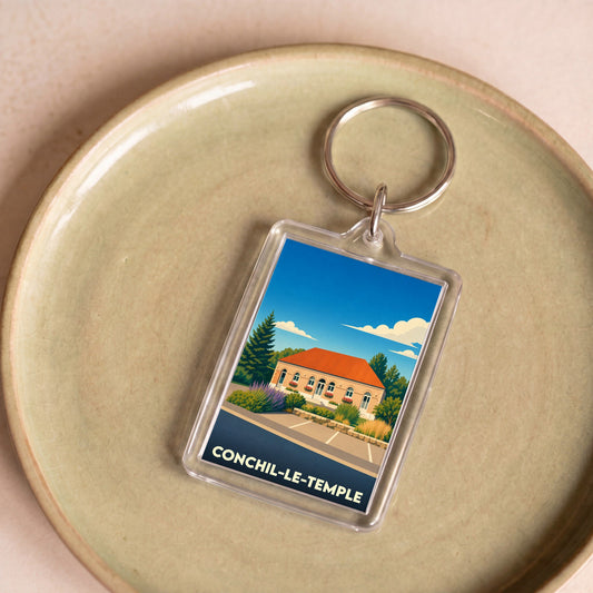 Porte-clés souvenir de la ville de Conchil-le-Temple avec une illustration stylisée.