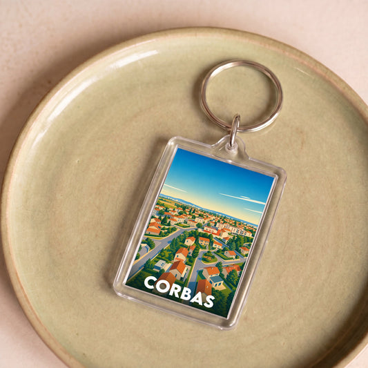 Porte-clés souvenir de la ville de Corbas avec une illustration stylisée vue du ciel.