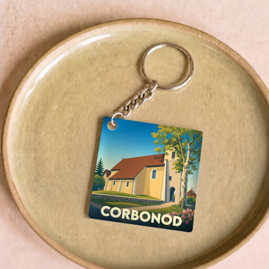 Porte-clés souvenir de la ville de Corbonod avec une illustration stylisée de son église.