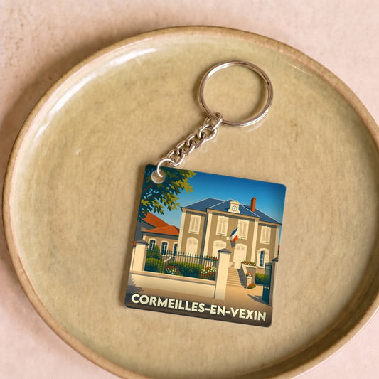 Porte-clés souvenir de la ville de Cormeilles-en-Vexin avec une illustration stylisée de sa mairie.