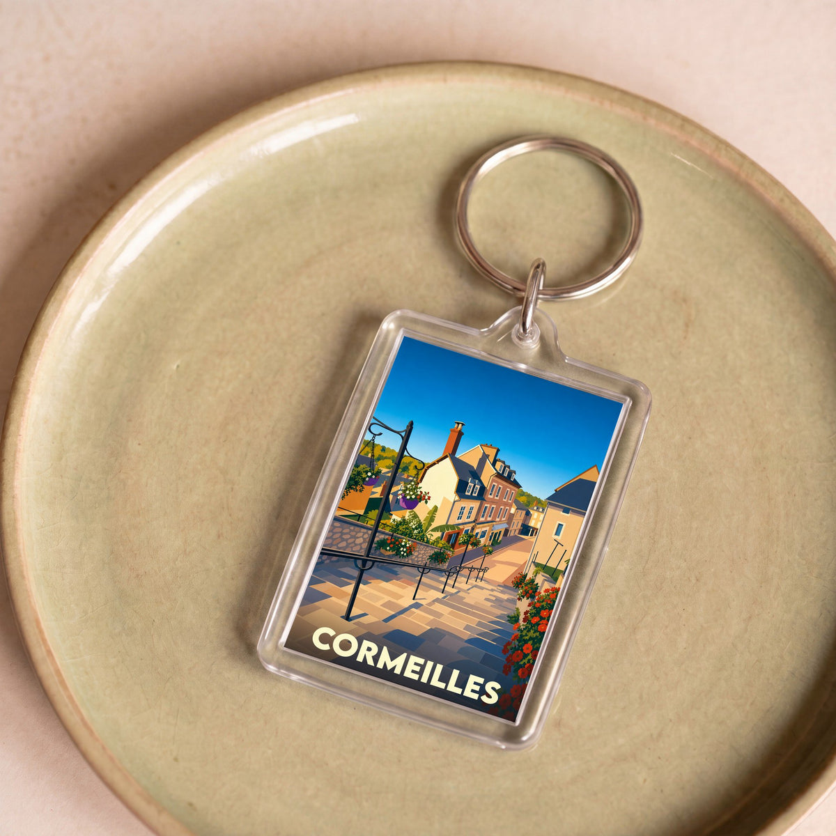 Porte-clés souvenir de la ville de Cormeilles avec une illustration stylisée.