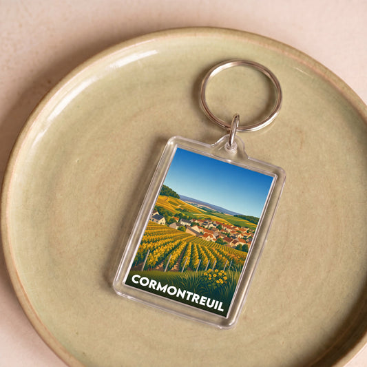 Porte-clés souvenir de la ville de Cormontreuil avec une illustration stylisée de vignobles.