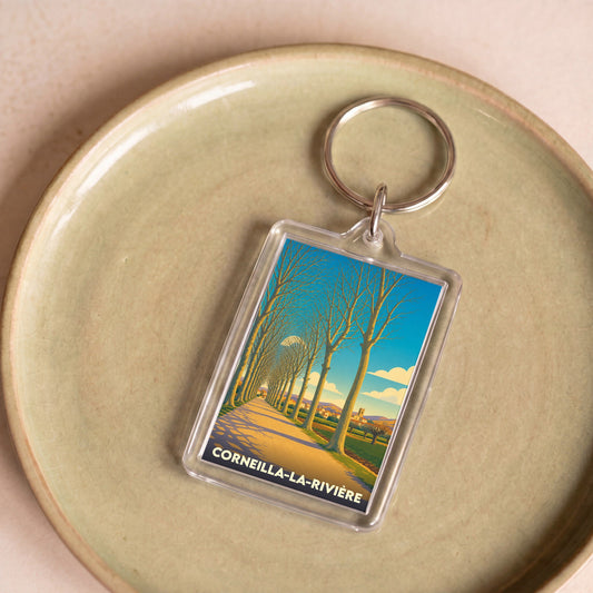 Porte-clés souvenir de la ville de Corneilla-la-Rivière avec une illustration stylisée.