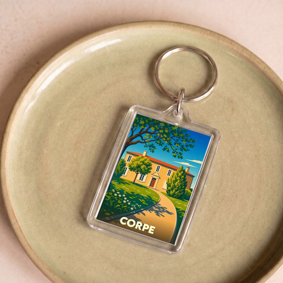 Porte-clés souvenir de la ville de Corpe avec une illustration stylisée.