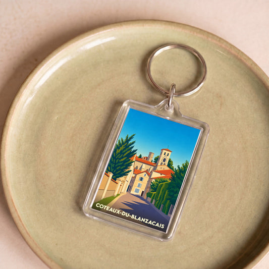 Porte-clés souvenir de la ville de Coteaux-du-Blanzacais avec une illustration stylisée.