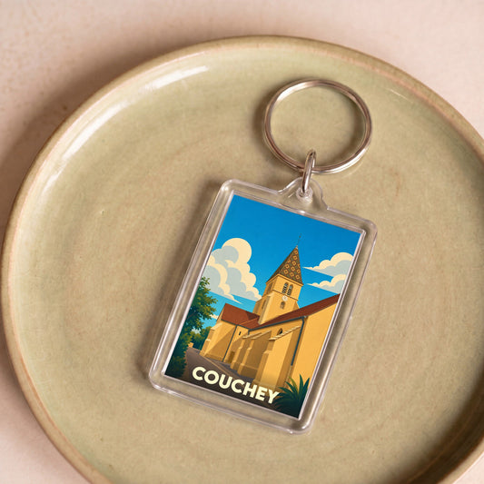 Porte-clés souvenir de la ville de Couchey avec une illustration stylisée de son église.