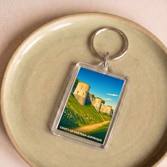 Porte-clés souvenir de la ville de Coucy-le-Château-Auffrique avec une illustration stylisée.