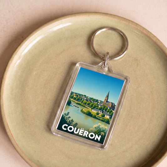 Porte-clés souvenir de la ville de Couëron avec une illustration stylisée du paysage.