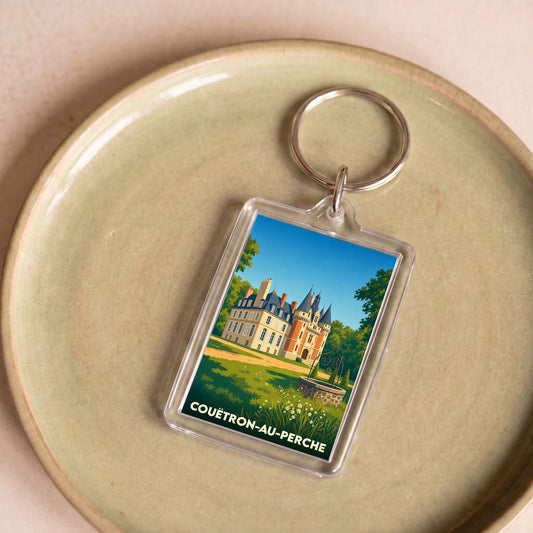 Porte-clés souvenir de la ville de Couëtron-au-Perche avec une illustration stylisée de son château.