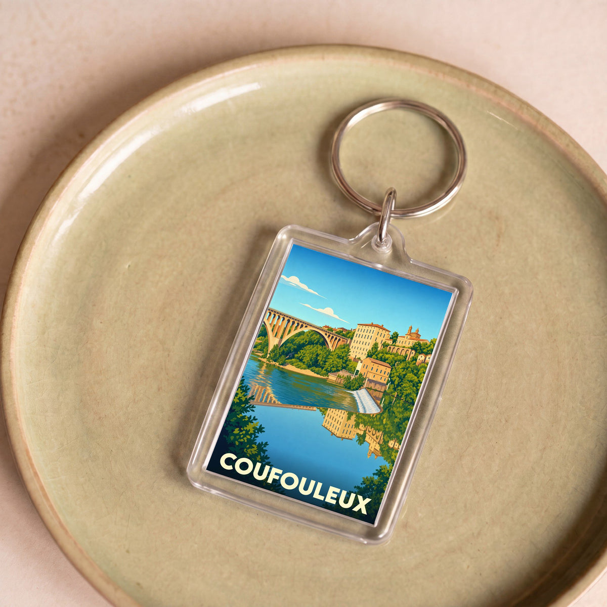 Porte-clés souvenir de la ville de Coufouleux avec une illustration stylisée.