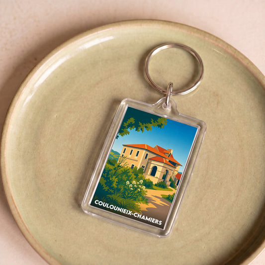 Porte-clés souvenir de la ville de Coulounieix-Chamiers avec une illustration stylisée.