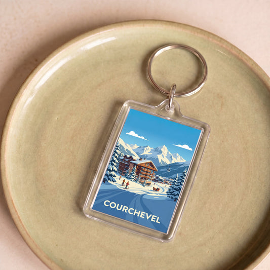 Porte-clés souvenir de la ville de Courchevel avec une illustration stylisée d'un paysage de montagne enneigé.