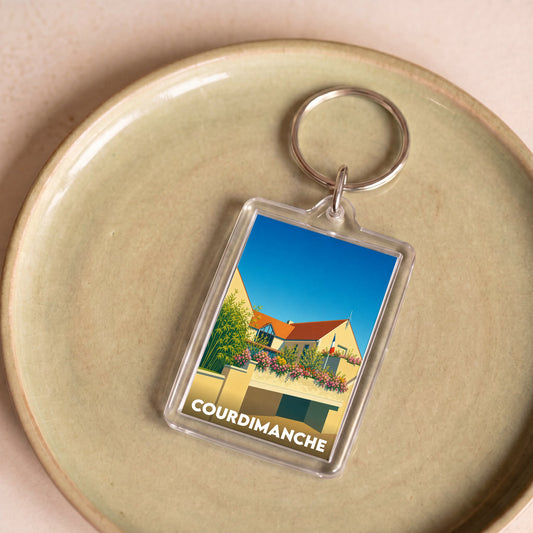 Porte-clés souvenir de la ville de Courdimanche avec une illustration stylisée de la mairie.