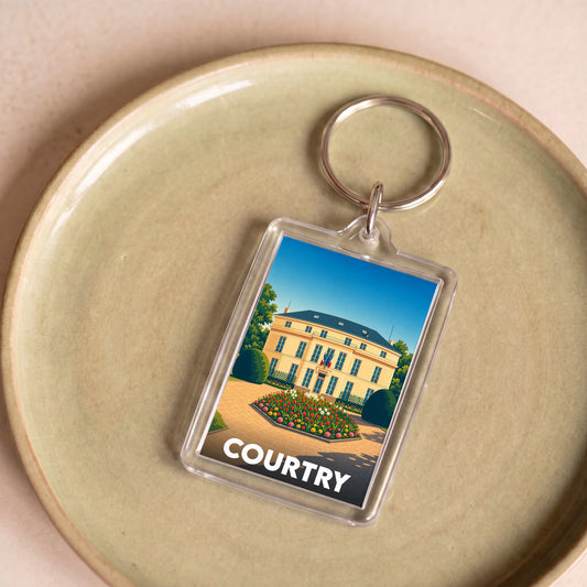 Porte-clés souvenir de la ville de Courtry avec une illustration stylisée de sa mairie.