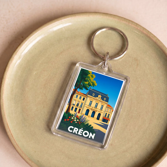 Porte-clés souvenir de la ville de Créon avec une illustration stylisée.