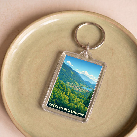 Porte-clés souvenir de la ville de Crêts en Belledonne avec une illustration de paysage montagneux.