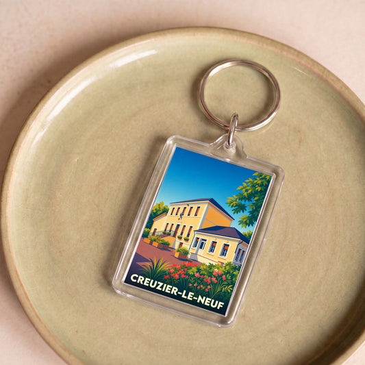 Porte-clés souvenir de la ville de Creuzier-le-Neuf avec une illustration stylisée.