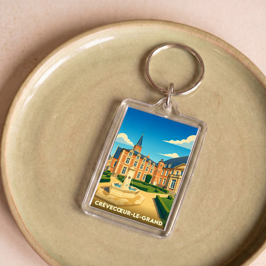 Porte-clés souvenir de la ville de Crèvecœur-le-Grand avec une illustration stylisée de son château.