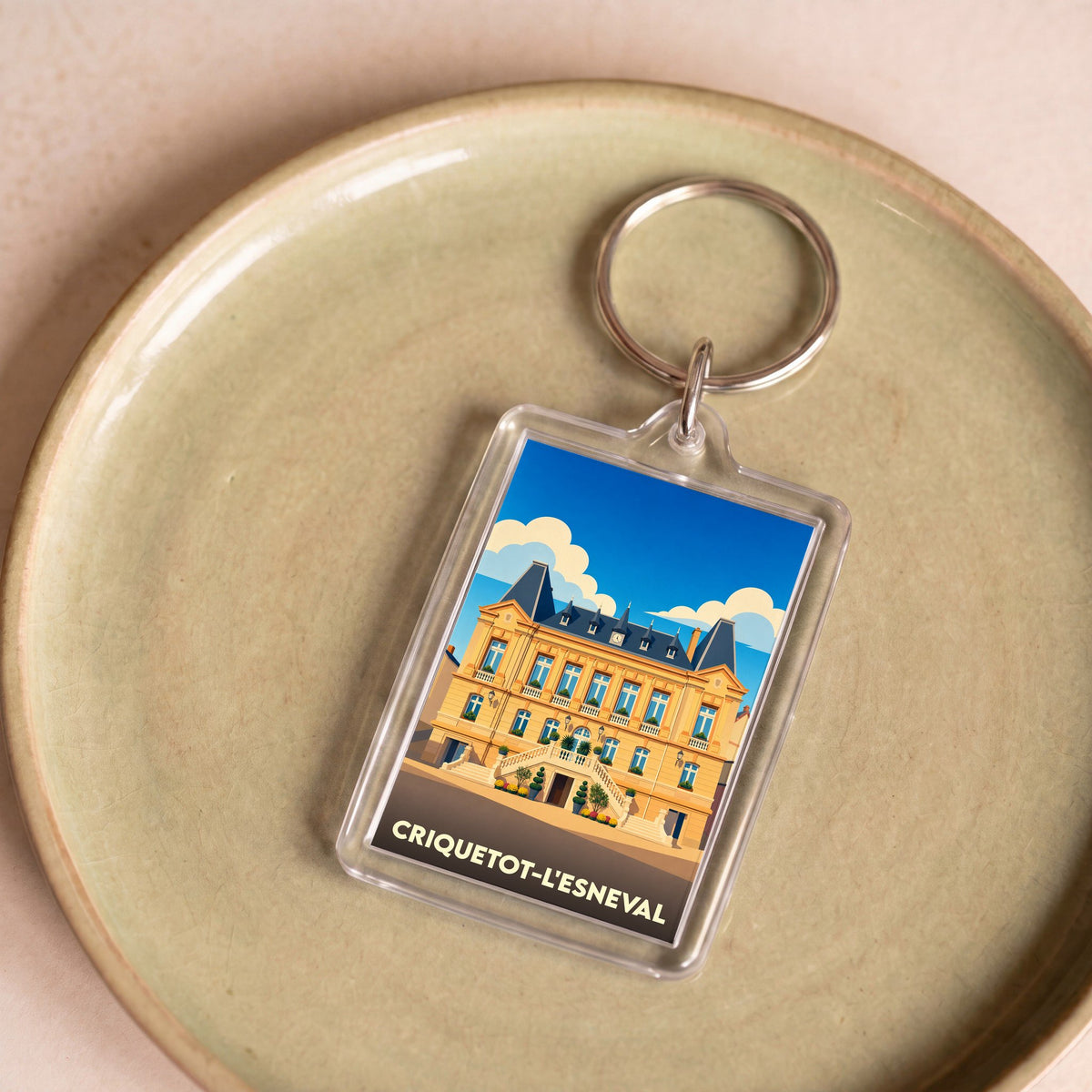 Porte-clés souvenir de la ville de Criquetot-l'Esneval avec une illustration stylisée.