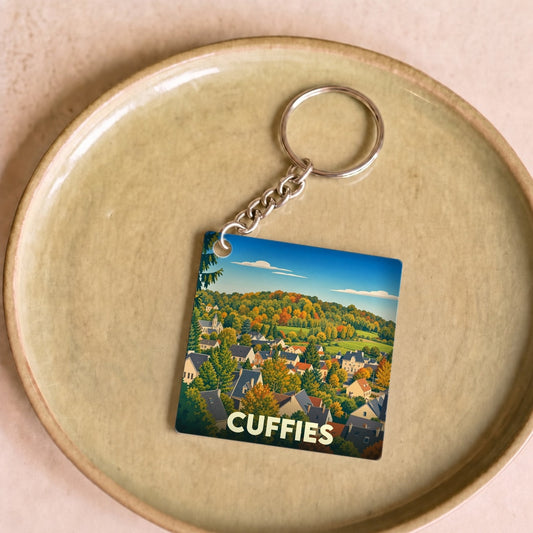 Porte-clés souvenir de la ville de Cuffies avec une illustration stylisée d'un paysage automnal.