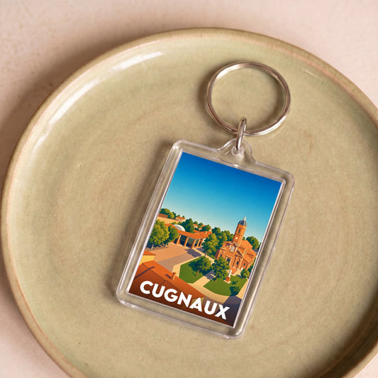 Porte-clés souvenir de la ville de Cugnaux avec une illustration stylisée.