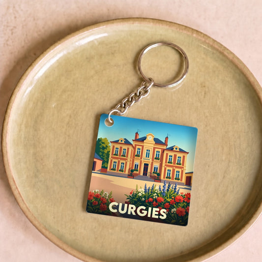 Porte-clés souvenir de la ville de Curgies avec une illustration stylisée de sa mairie.