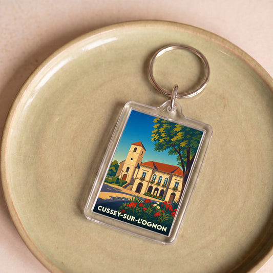 Porte-clés souvenir de la ville de Cussey-sur-l'Ognon avec une illustration stylisée.