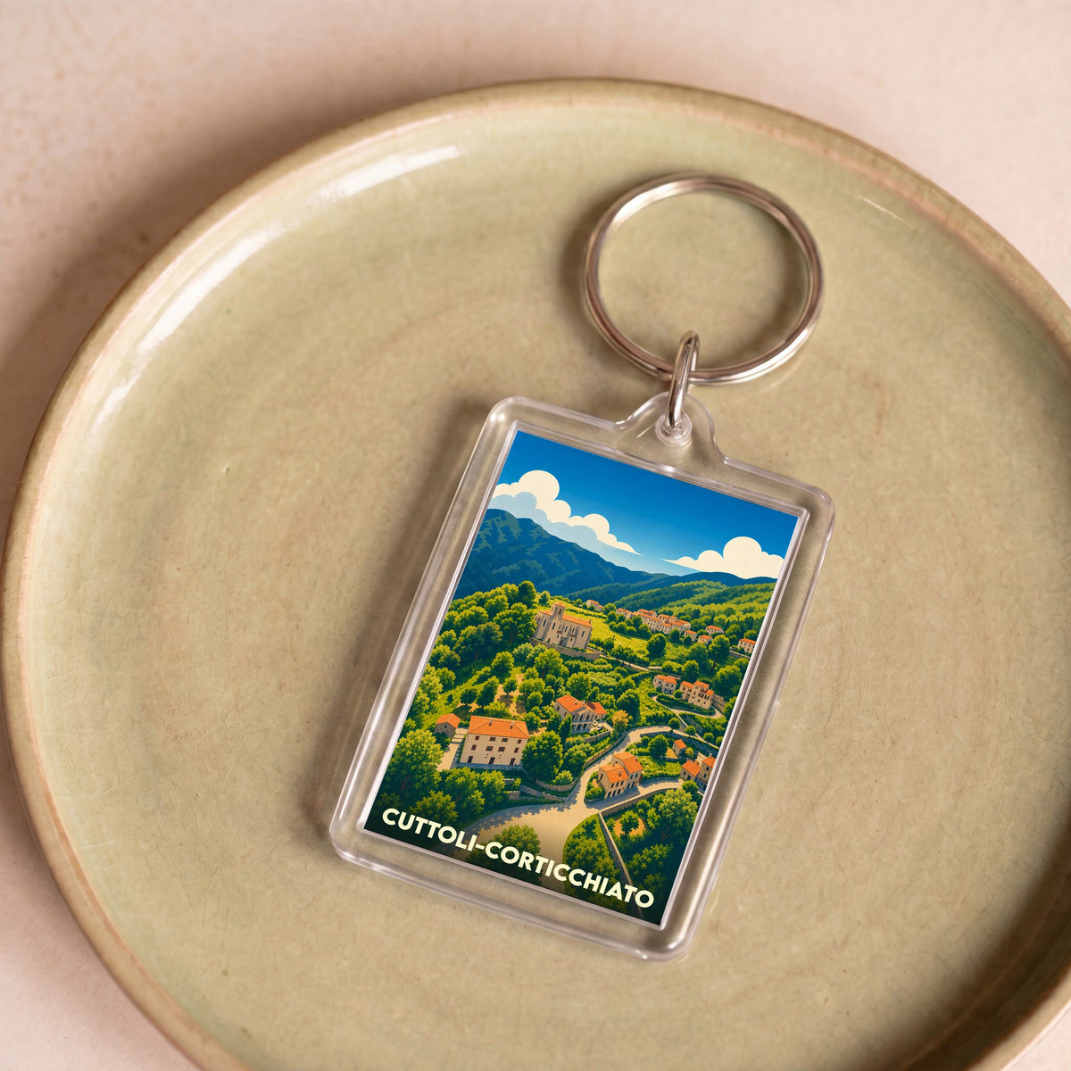 Porte-clés souvenir de la ville de Cuttoli-Corticchiato avec une illustration stylisée.