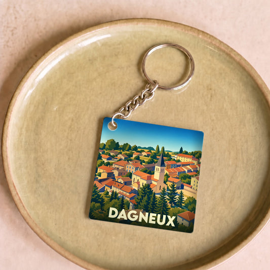 Porte-clés souvenir de la ville de Dagneux avec une illustration stylisée.