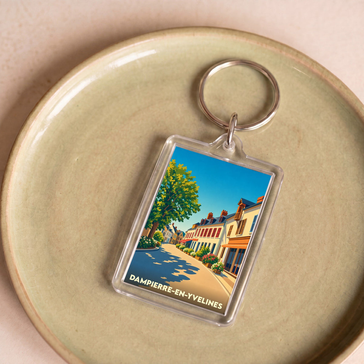 Porte-clés souvenir de la ville de Dampierre-en-Yvelines avec une illustration stylisée.