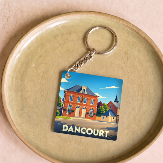 Porte-clés souvenir de la ville de Dancourt avec une illustration stylisée de sa mairie.