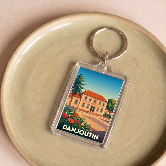 Porte-clés souvenir de la ville de Danjoutin avec une illustration stylisée.