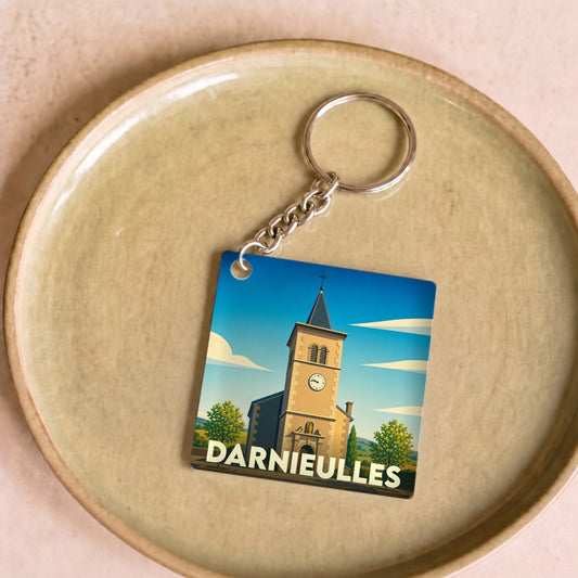 Porte-clés souvenir de la ville de Darnieulles avec une illustration stylisée de son église.