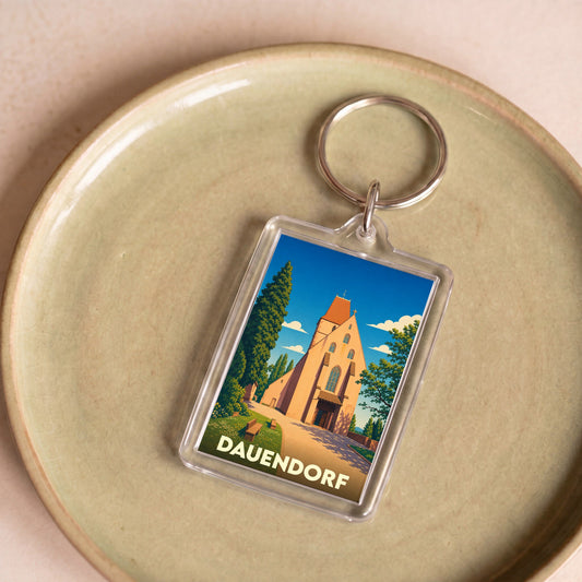 Porte-clés souvenir de la ville de Dauendorf avec une illustration stylisée de son église.