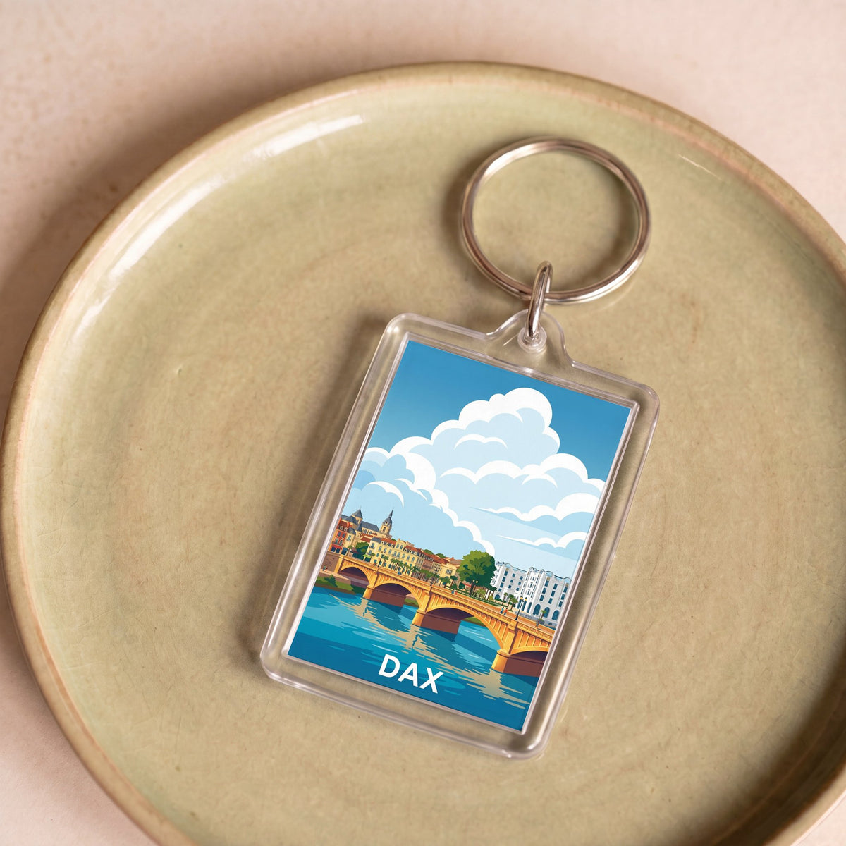 Porte-clés souvenir de la ville de Dax avec une illustration stylisée.