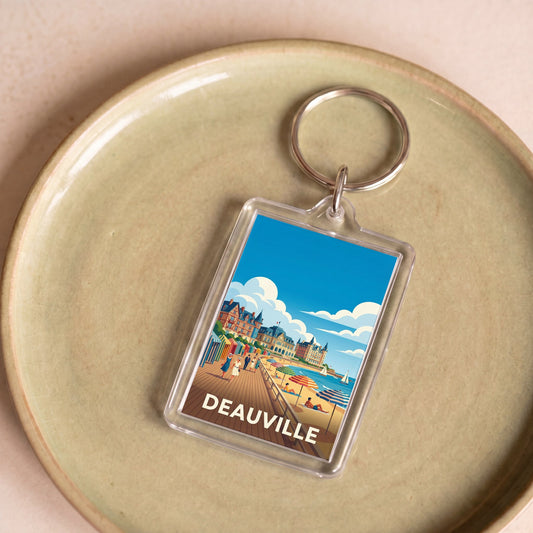 Porte-clés souvenir de la ville de Deauville avec une illustration stylisée de sa plage.