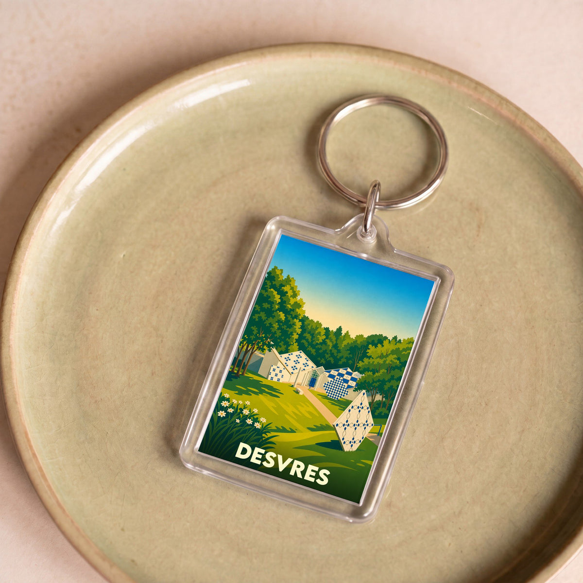 Porte-clés souvenir de la ville de Desvres avec une illustration stylisée.