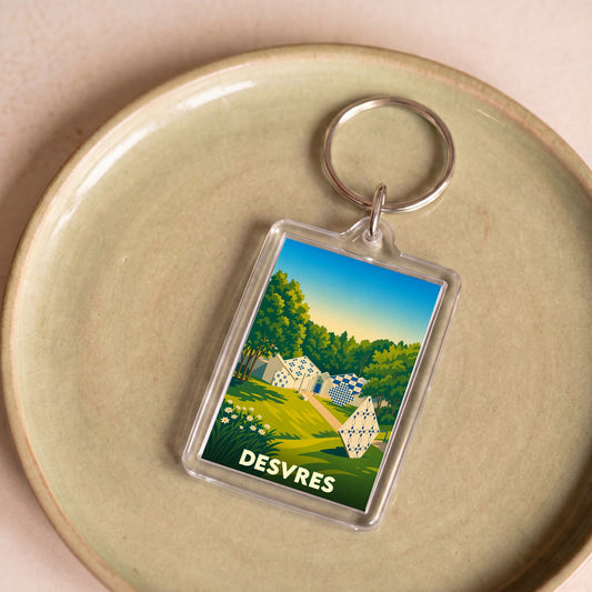 Porte-clés souvenir de la ville de Desvres avec une illustration colorée et stylisée.