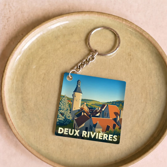 Porte-clés souvenir de la ville de Deux Rivières avec une illustration stylisée.