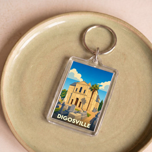 Porte-clés souvenir de la ville de Digosville avec une illustration stylisée d'une église et de son cimetière.
