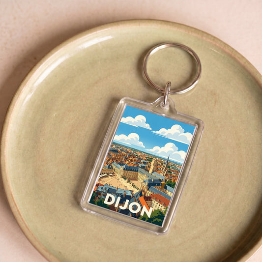 Porte-clés souvenir de la ville de Dijon avec une illustration stylisée du panorama urbain.