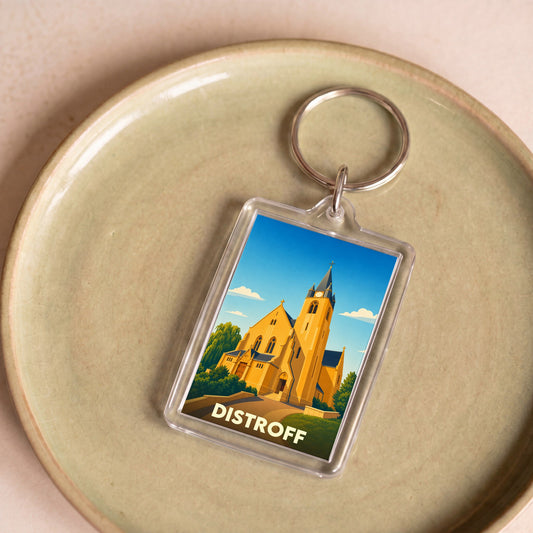 Porte-clés souvenir de la ville de Distroff avec une illustration stylisée de son église.