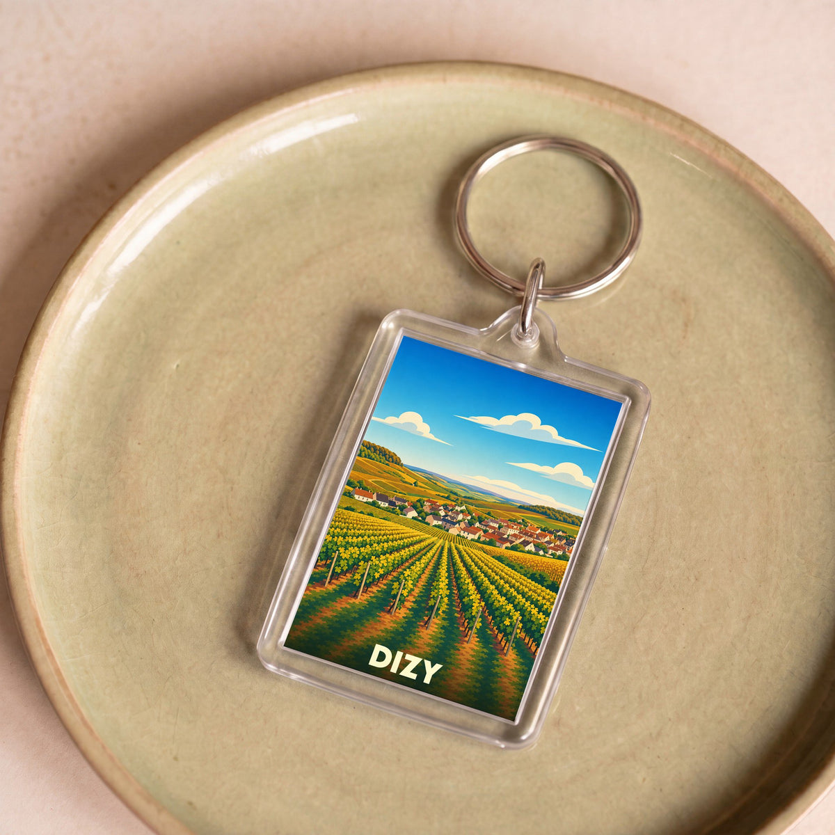 Porte-clés souvenir de la ville de Dizy avec une illustration stylisée de vignobles champenois.