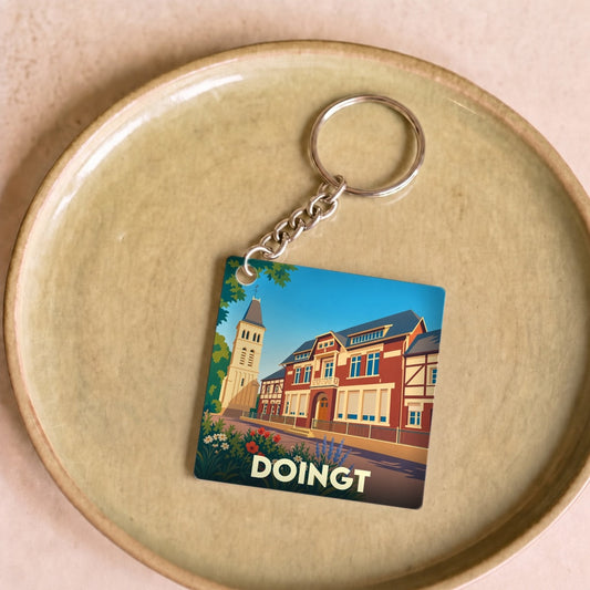 Porte-clés souvenir de la ville de Doingt avec une illustration stylisée.